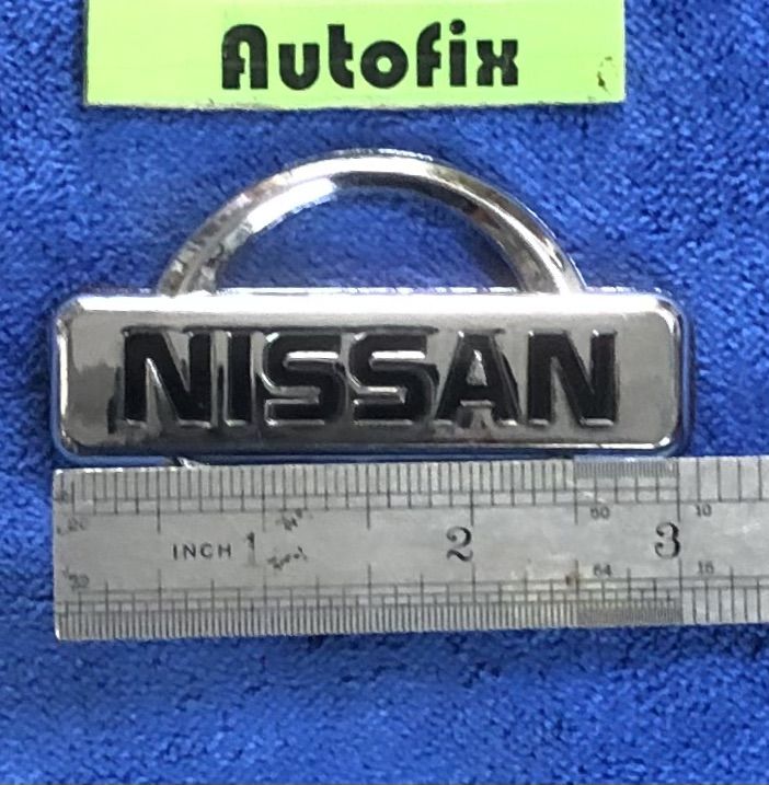 Nissan%20Plastic%20Stylish%20Logo%20Silver%2003%20Inches%2001%20Piece%20-%20Image%202